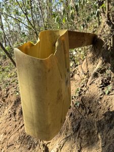 A local dustbin made of a cut jerrican nailed to a log seen at the source of the Nile. 
