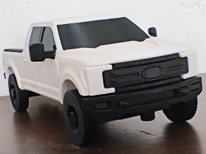 White 3D-printed pickup truck model with black wheels and detailing