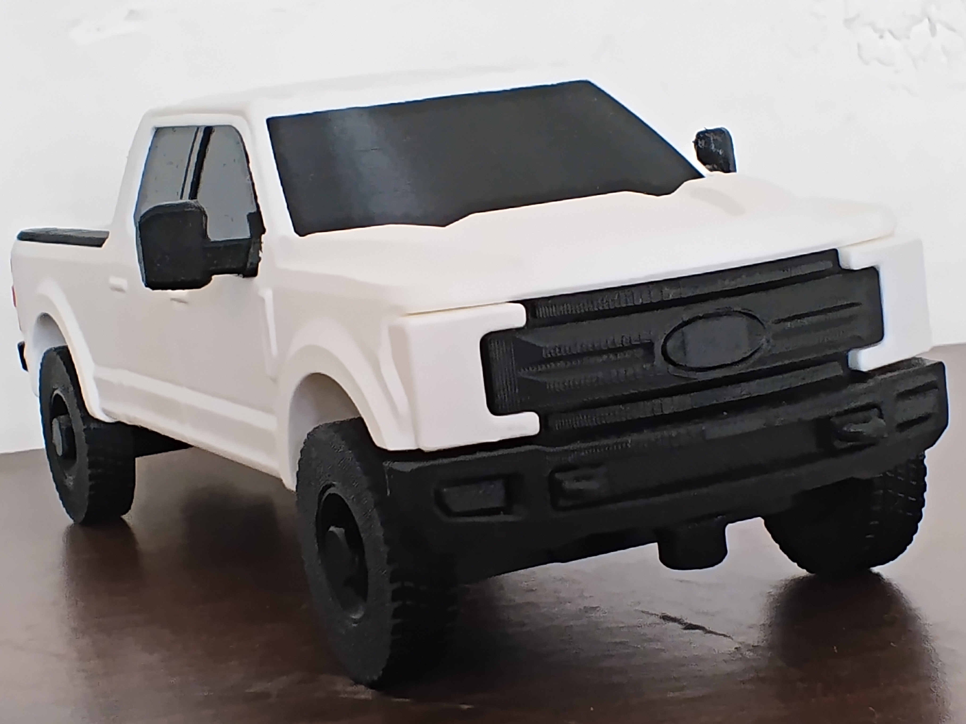 White 3D-printed pickup truck model with black wheels and detailing