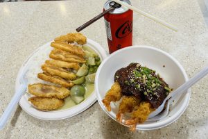 Crispy fried shrimp and golden chicken with rice, curry, and Coke.