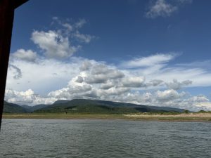 Sadapathor, Bholaganj, Sylhet, with green hills and a calm river.