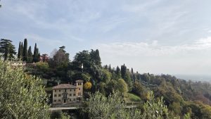 Scenic hillside landscape of Asolo, a historic town in the Veneto region of northern Italy, featuring the classic architecture and olive and cypress trees typical of the area.