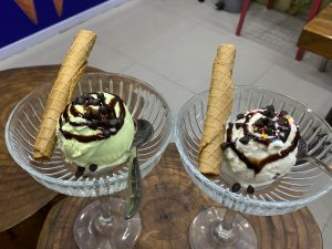 Two glass cups of ice cream, one pale green and one white with sprinkles, topped with chocolate and wafer rolls.
#Wordpresscommunity
